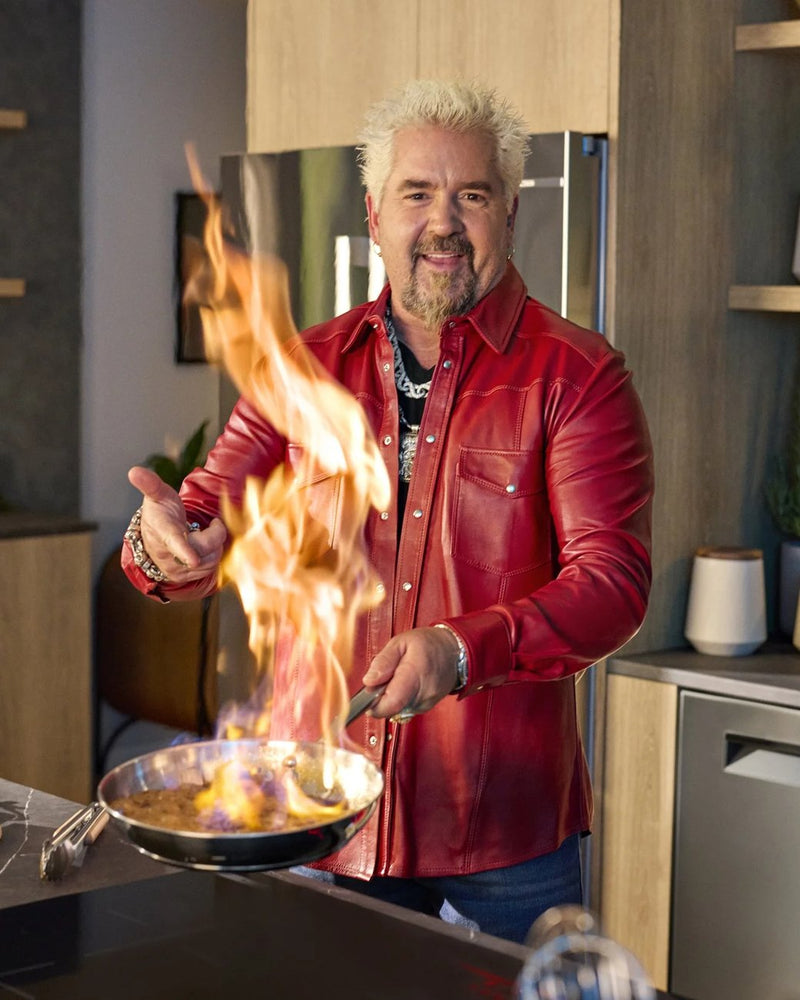 Guy Fieri cooking with fire in a Ron Tomson red leather shirt