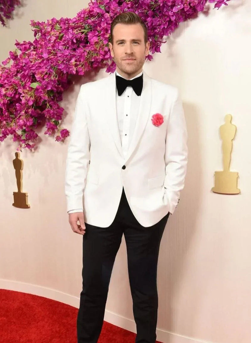 Scott Evans in a Ron Tomson shawl lapel tuxedo at the 2024 Oscars, where he shared a viral moment with Ryan Gosling during the I'm Just Ken performance