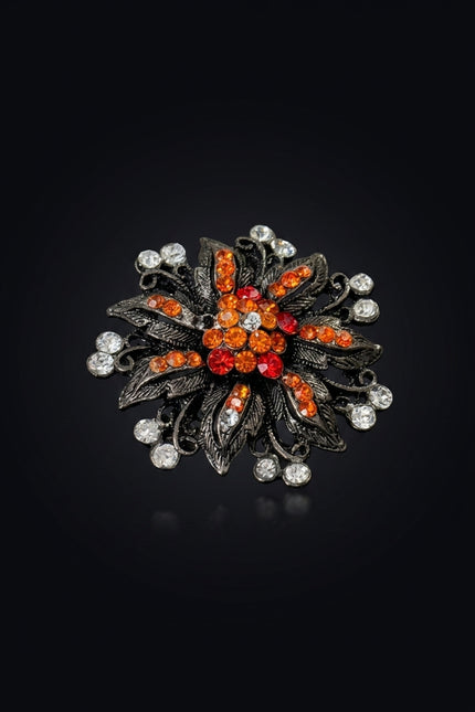 Brooch - Gunmetal Orange Red Clear floral starburst - angle