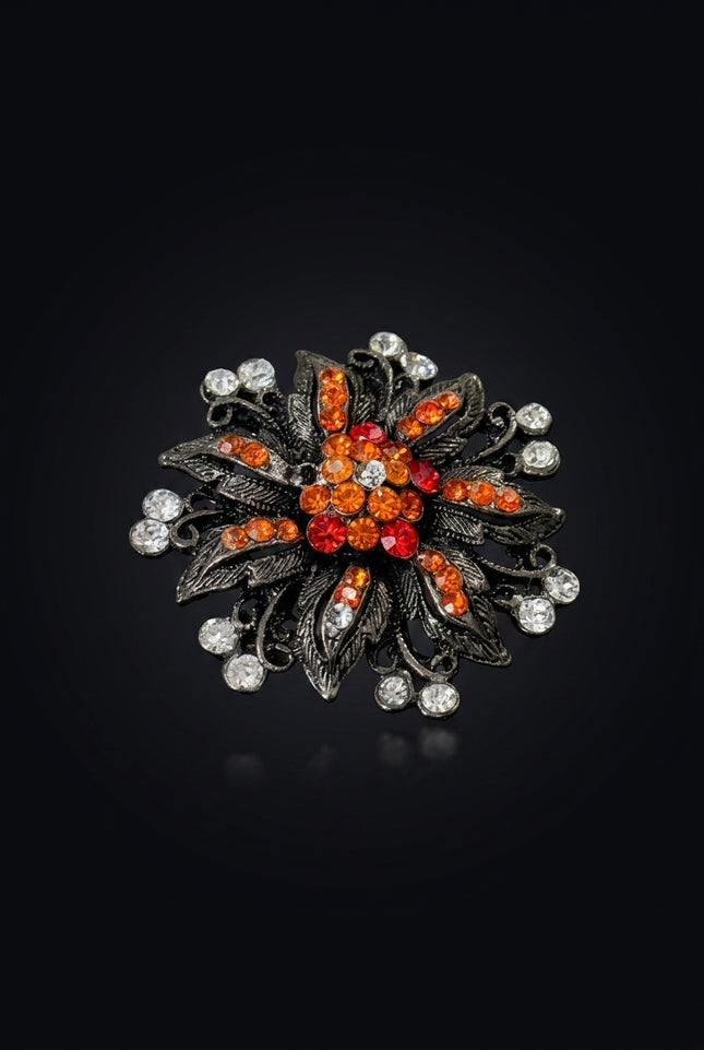 Brooch - Gunmetal Orange Red Clear floral starburst - angle