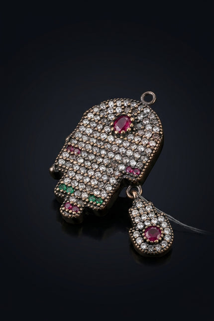 Brooch - Dark Metal, Clear, Red, Green Stones hamsa hand - angle