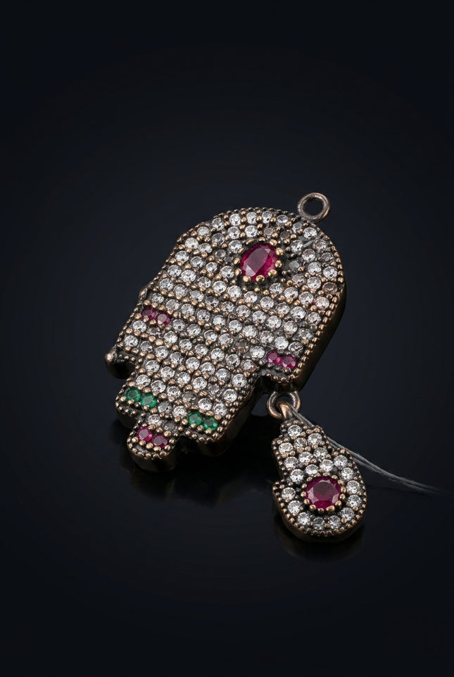 Brooch - Dark Metal, Clear, Red, Green Stones hamsa hand - angle