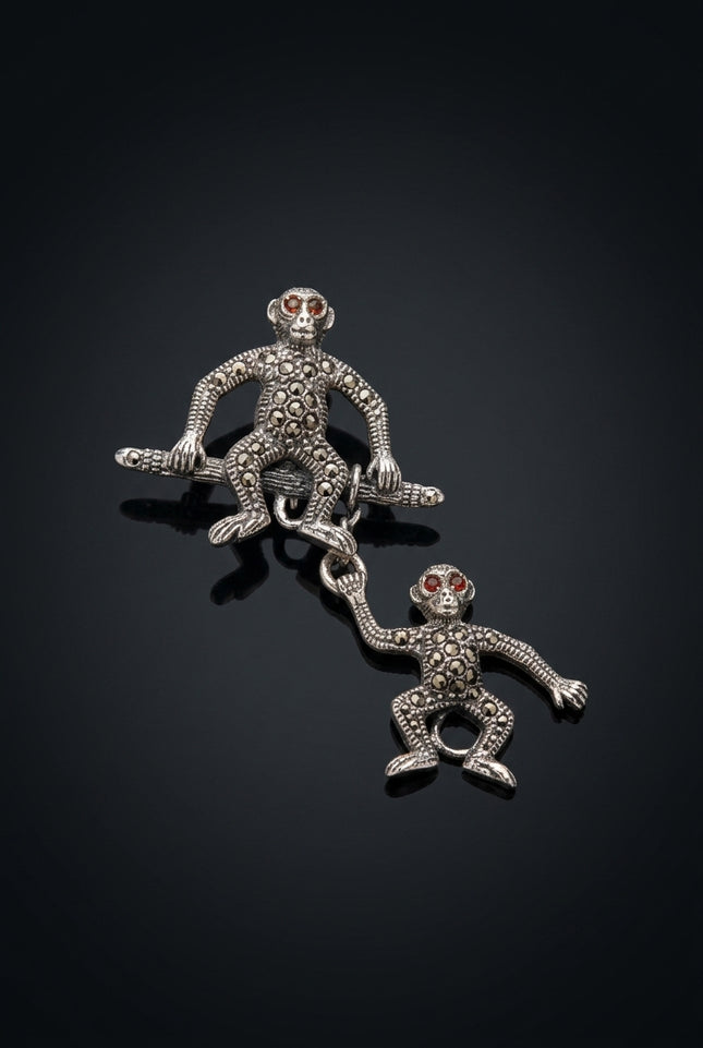 Brooch - Silver two monkey figures, one hanging from the other - angle