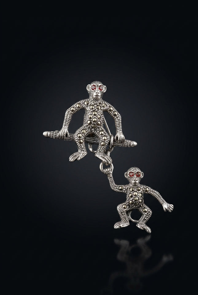 Brooch - Silver two monkey figures, one hanging from the other - front