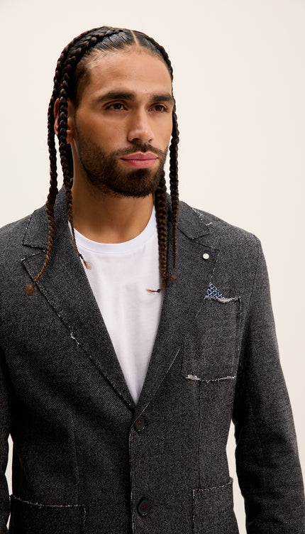 Man wearing a gray suit with a white shirt against a beige background