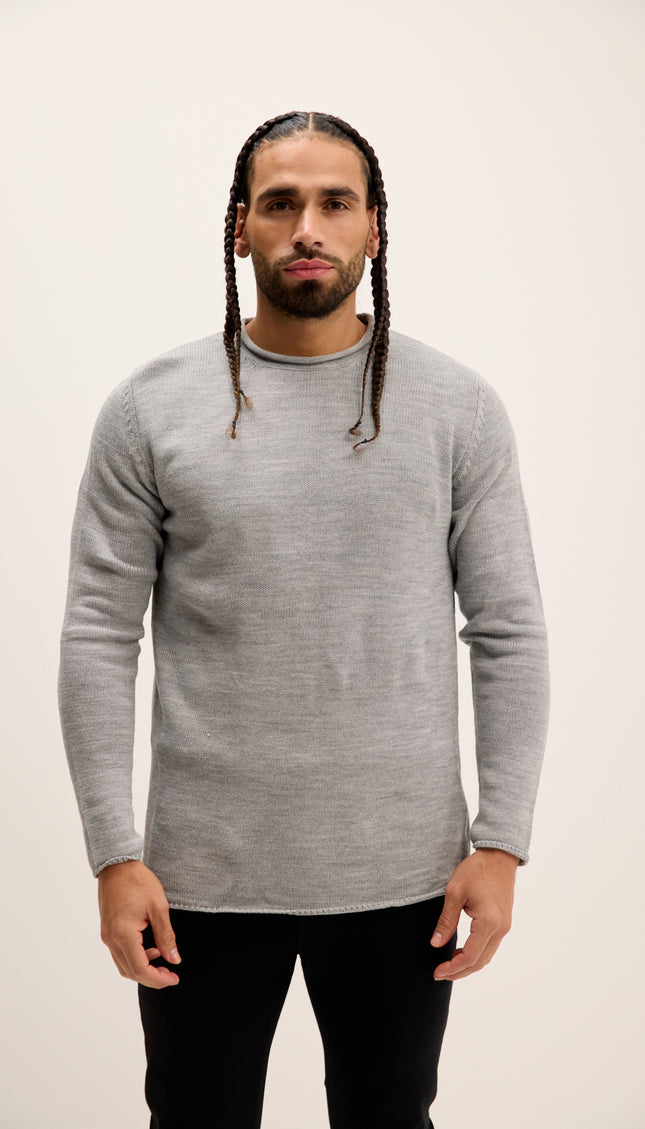 Man wearing a gray sweater against a plain background