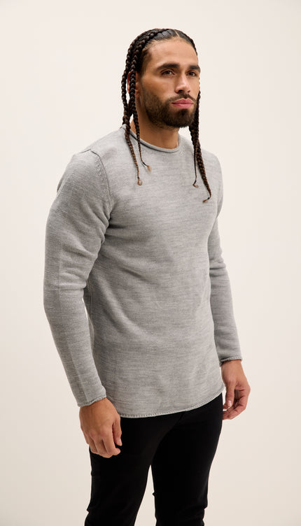 Man wearing a gray long-sleeve shirt against a plain background