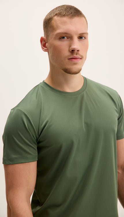 Man wearing a green t-shirt against a plain background