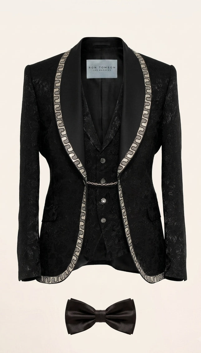Full view of Ron Tomson Black Baroque Jacquard Mens Tuxedo Suit with silver chain trim lapels, vest, shirt, and bow-tie.
