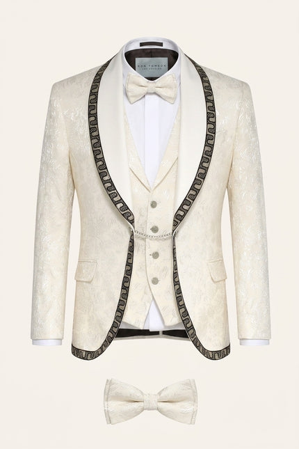 Cream floral brocade shawl lapel tuxedo suit with intricate decorative trim, matching vest, and bow tie for mens formal wear.