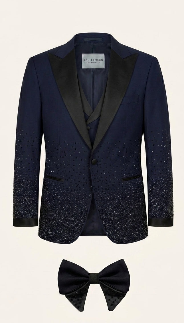 Ron Tomson Midnight Sparkle navy blue tuxedo suit with gradient rhinestone embellished jacket, satin lapels, double-breasted vest, and bow tie.