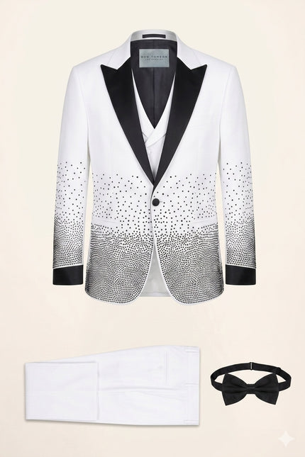 White sequin embellished mens tuxedo suit with black satin shawl lapels and matching pants, vest, and bow tie.